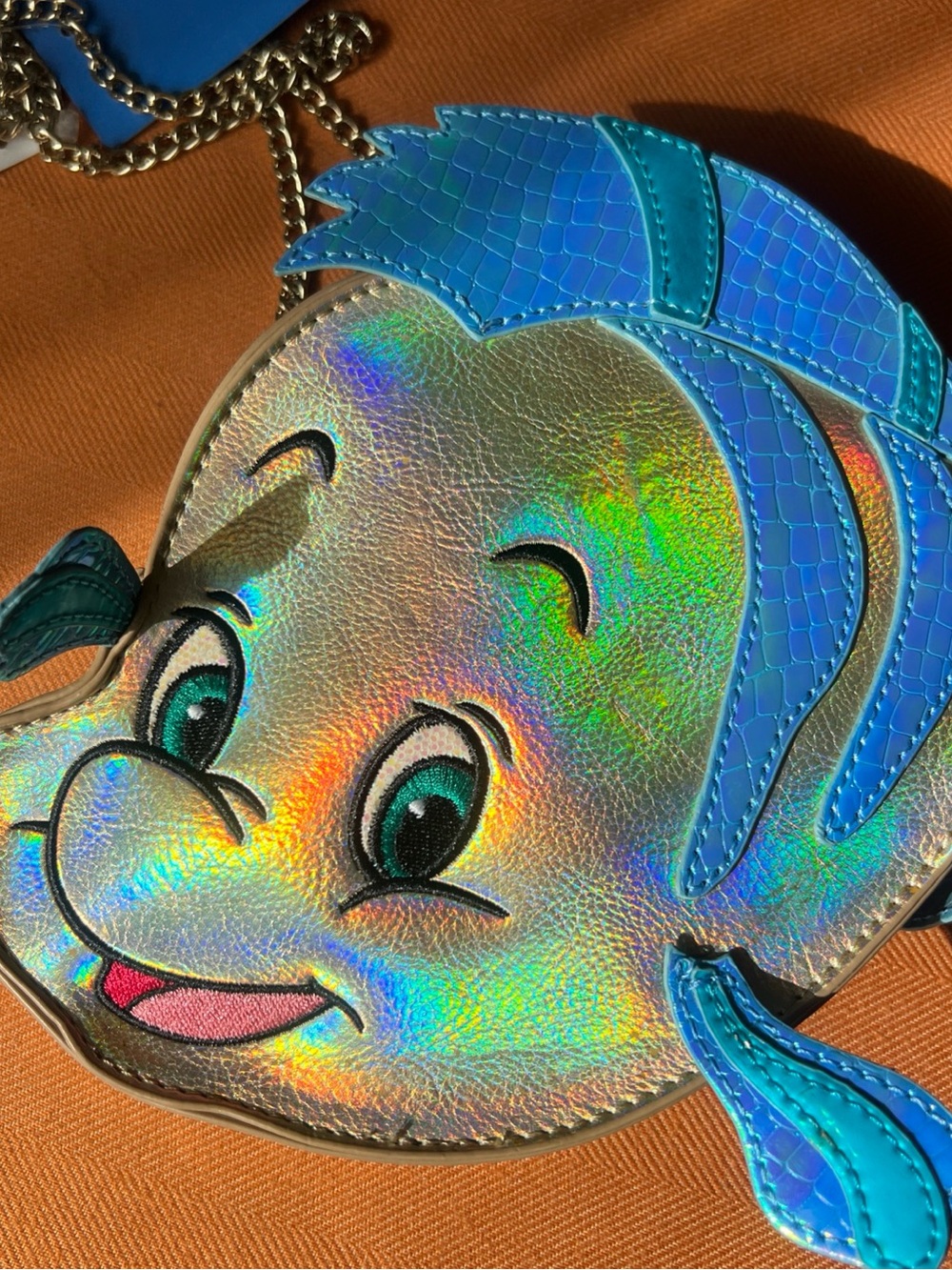 Danielle Nicole Disney Kids Holographic Flounder Crossbody Bag in gold blue